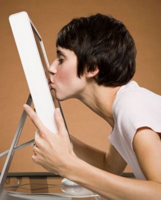 computer_love - A woman is kissing her computer screen and hoping that she can avoid data recovery.